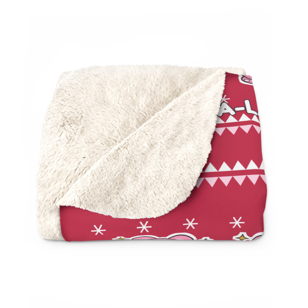Pink koala Christmas blanket draped over a sofa in a living room