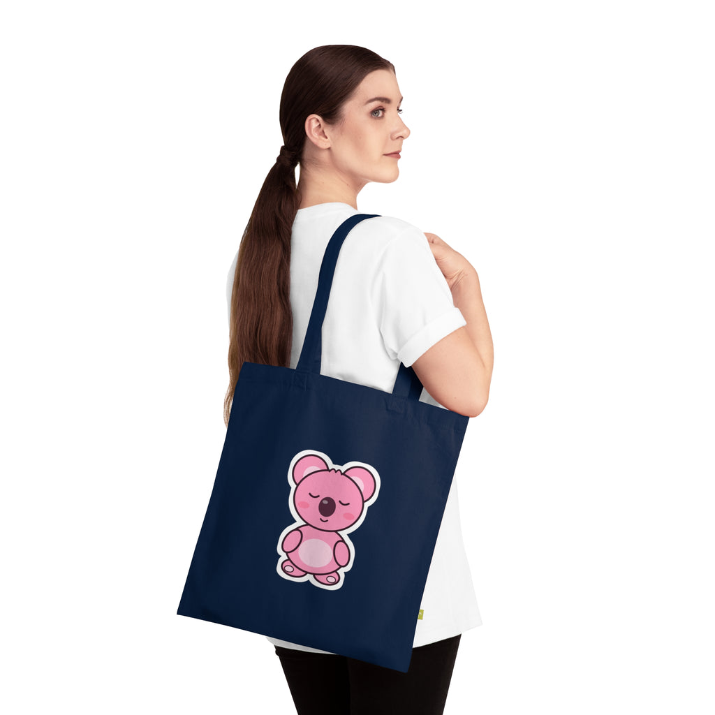 Sleepy Koa tote bag flat lay with denim and sunflower