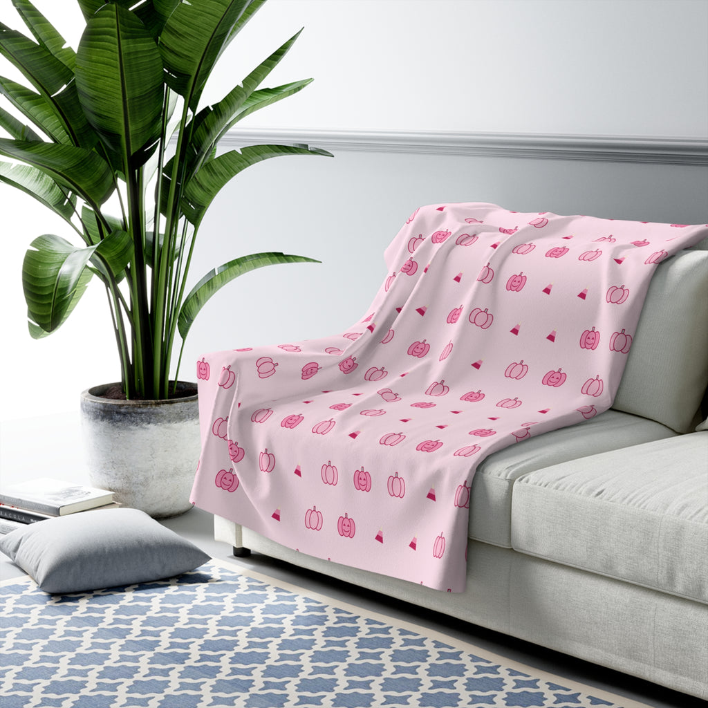 Pink pumpkin fleece blanket over a crib rail