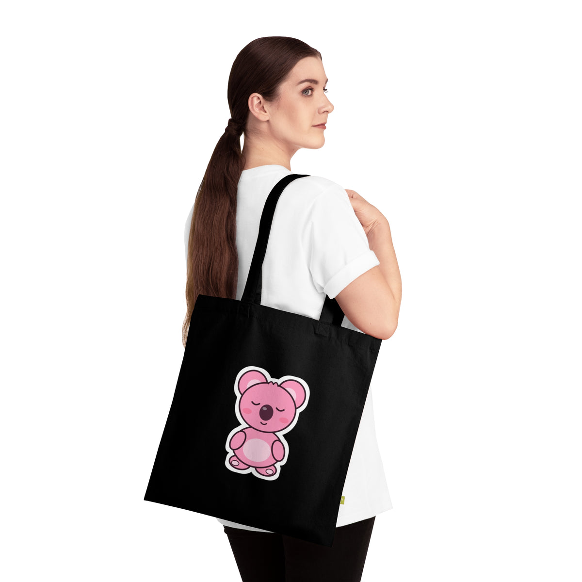 Person carrying the black Sleepy Koa tote bag